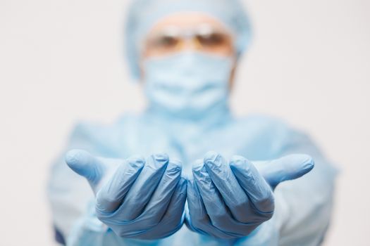 Close up of doctor hand holding. Mock up. Medical equipment. A doctor wearing personal protective equipment including mask, goggle, and suit to protect COVID 19 coronavirus infection.