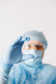 Close up of doctor hand holding. Mock up. Medical equipment. A doctor wearing personal protective equipment including mask, goggle, and suit to protect COVID 19 coronavirus infection.