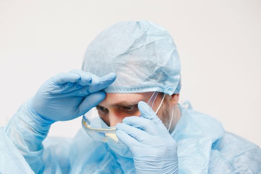 Close up of doctor. Medical equipment. A doctor wearing personal protective equipment including mask, goggle, and suit to protect COVID 19 coronavirus infection.