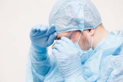 Close up of doctor. Medical equipment. A doctor wearing personal protective equipment including mask, goggle, and suit to protect COVID 19 coronavirus infection.