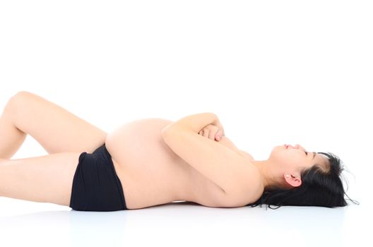 Beautiful pregnant naked asian woman posing laying down