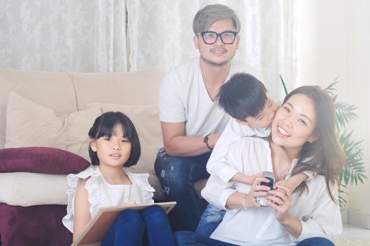 Asian family enjoying family life at living room