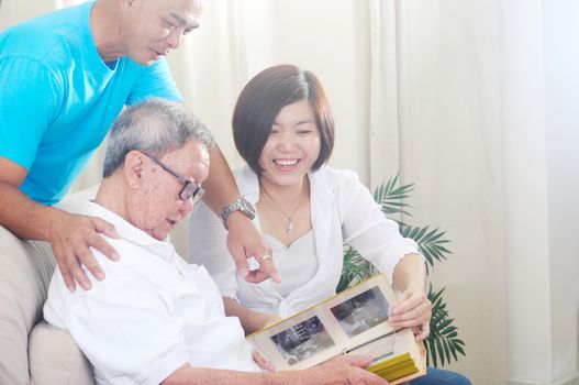 Asian senior father with his adult son and daughter at home. Family living lifestyle.