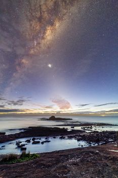 Stary night sky and milky way setting over the coast of Haycock Point in Ben Boyd National Park, Australia