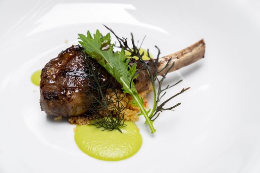 Grilled lamb chop with pesto sauce, international gourmet cuisine a la carte in buffet live station. Using for food and drink industry.