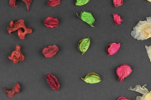 Potpourri on a black background. Flavored potpourri leaves. Dry potpourri leaves close-up. Geometric pattern. Closeup