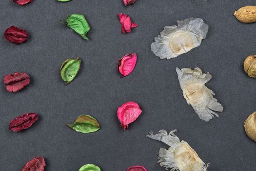 Fragrant potpourri on black background, top view. Geometric background, close-up