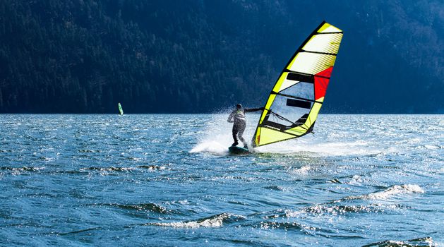 Lifestyle windsurfer on lake Alpnach in Switzerland during a windy spring day