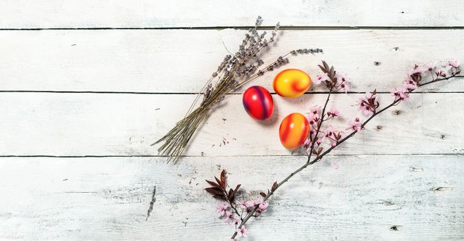 colored easter egg on wood background with copy space