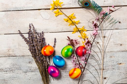 colored easter egg on wood background with copy space