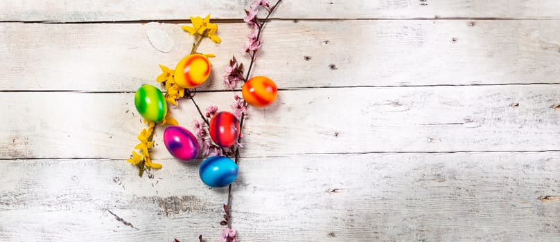 colored easter egg on wood background with copy space