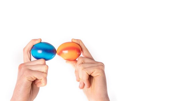 colored eggs with hands tapping and crushing eggs with copy space