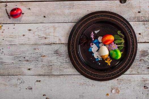 colored easter egg on wood background with copy space