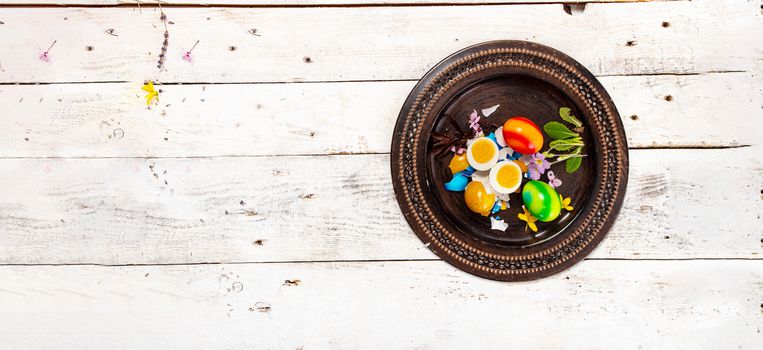 colored easter egg on wood background with copy space