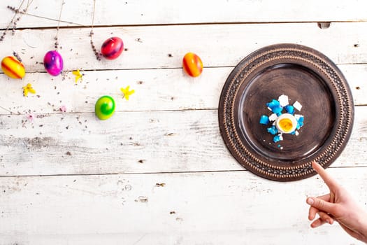 colored easter egg on wood background with copy space