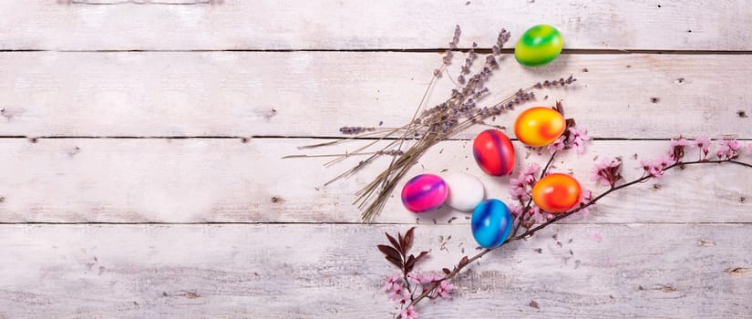 colored easter egg on wood background with copy space