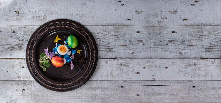 colored easter egg on wood background with copy space