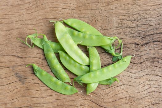 Sugar Pea, Snow peas on plank wooden background