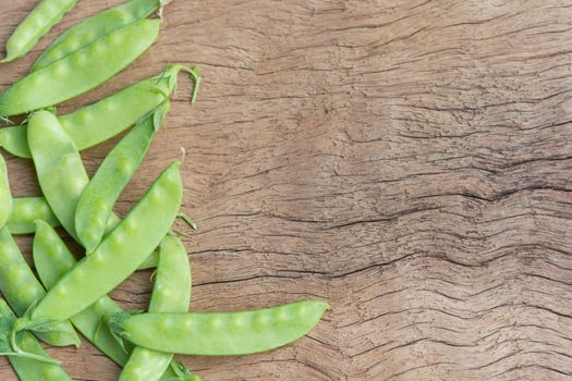 Sugar Pea, Snow peas on plank wooden background