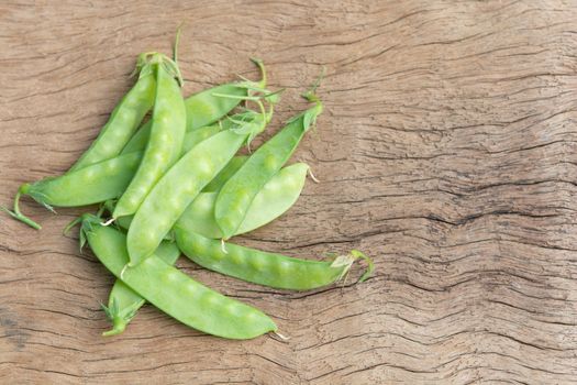 Sugar Pea, Snow peas on plank wooden background