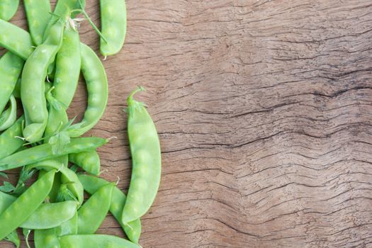 Sugar Pea, Snow peas on plank wooden background