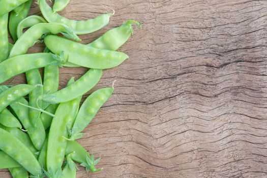 Sugar Pea, Snow peas on plank wooden background