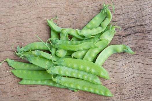 Sugar Pea, Snow peas on plank wooden background