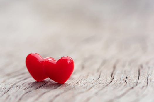 Valentines Day concept -  Red hearts on plank wooden background with copy space
