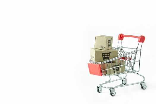 Shopping concept : Cartons or Paper boxes in red shopping cart on white background. online shopping consumers can shop from home and delivery service. with copy space