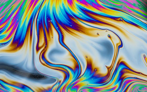 Psychedelic multicolored patterns background. Photo macro shot of soap bubbles
