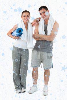 Composite image of Portrait of a couple going to practice yoga with snow falling