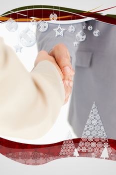 Composite image of People shaking hands with christmas frame