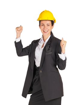 A businesswoman wearing a yellow construction helmet smile while raising her fist up. Portrait on white background with studio light.
