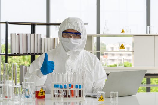 Asian scientist posing confidently in the laboratory. 