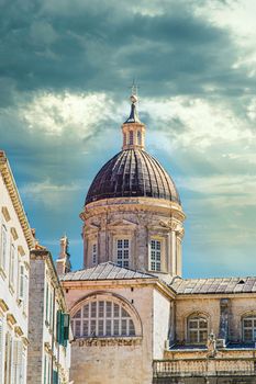 Old domed church in the walled city of Dubrovnik under dramatic skies