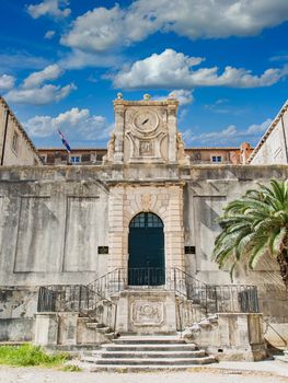 An old stone government building in Dubrovnik with clock