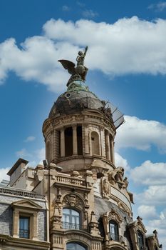 A winged statue on a domed building in Barcelona, Spain
