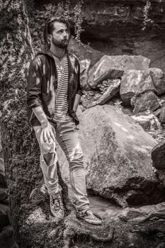 Portrait of a boy posing in the woods, image in black and white