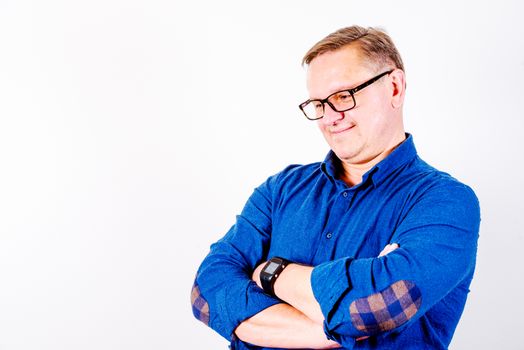 Smiling middle aged men in glasses and  blue shirt