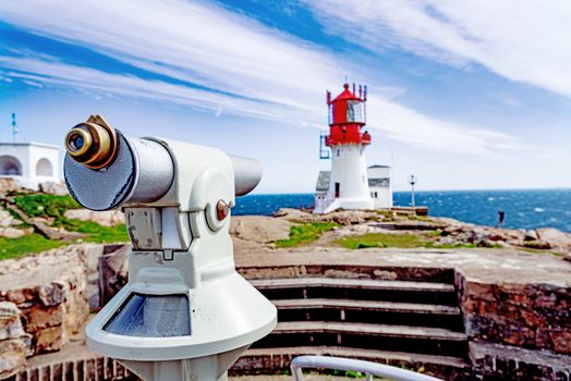 Observation telescope with Lindesnes Lighthouse on background, Norway