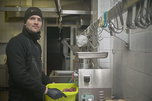 Butcher prepares the cuts of meat for sale