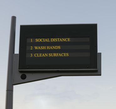 Bus station board billboard with three basic rules to avoid the coronavirus or Covid-19 epidemic of wash hands, maintain social distance and clean surfaces