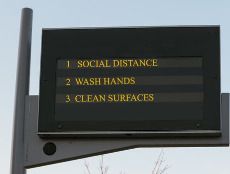 Bus station board billboard with three basic rules to avoid the coronavirus or Covid-19 epidemic of wash hands, maintain social distance and clean surfaces