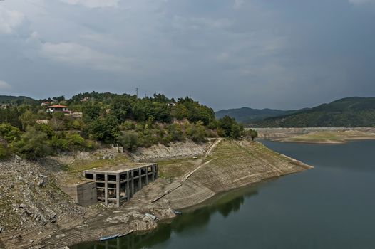 View from Topolnitsa dam, lake or barrage on the river Topolnitsa and part from village Muhovo, Ihtiman region, Bulgaria, Europe