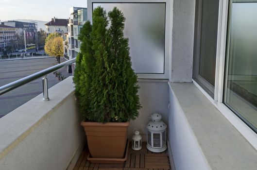 Balcony of a new apartment with  cypress flower in pot and lamp, town Kazanlak, Bulgaria