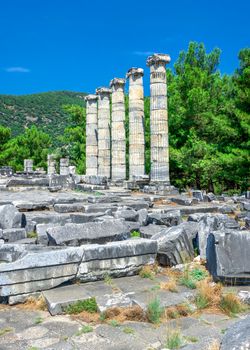 Ruins of the Temple of Athena Polias in the ancient city of Priene, Turkey, on a sunny summer day. Big panoramic shot.