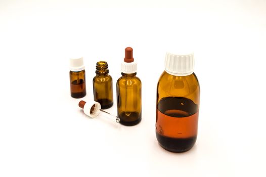 Four brown pharmacy bottles on a white background