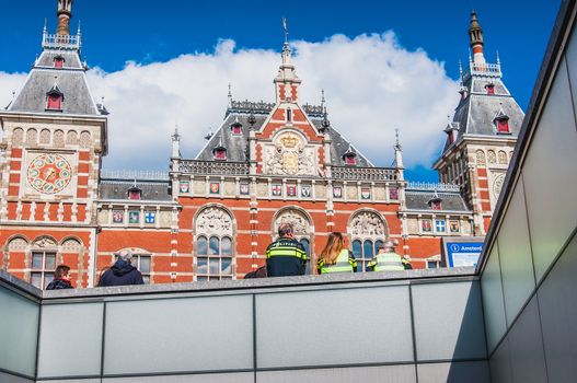 Policemen at Amsterdam Central Station on Damrak in the Netherlands