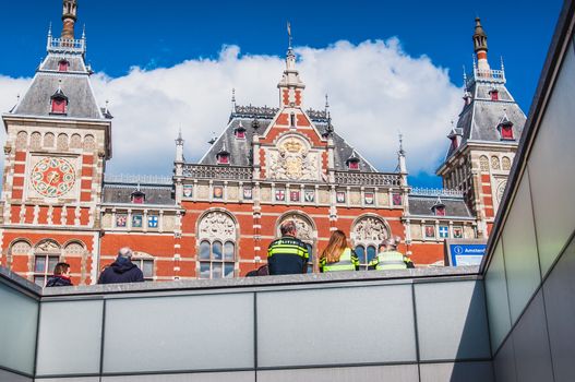 Policemen at Amsterdam Central Station on Damrak in the Netherlands
