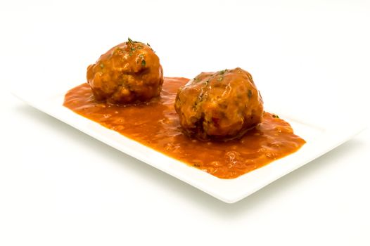 Meatballs cooked in tomato sauce on a white background